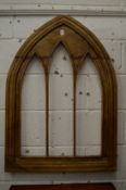 A hardwood arched shaped gothic design mirror frame.