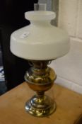 A brass and glass oil lamp style table lamp.