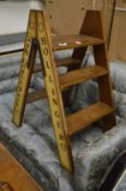 A pair of novelty step ladders with champagne names down the side.