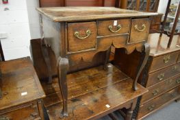 An 18th century oak lowboy (repairs).