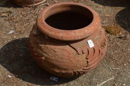 A weathered terracotta plant pot.
