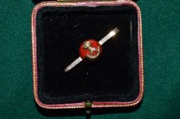 A 9ct gold and enamel brooch.