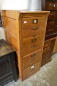 An old oak four drawer filing cabinet.