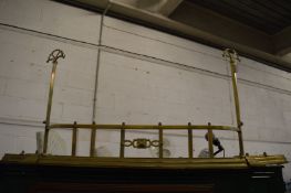 An Art Nouveau brass fender.