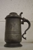 A pewter lidded tankard.