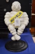 Cast iron Michelin man on stand.