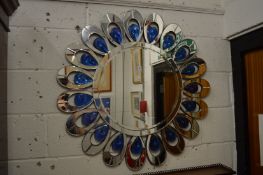 An ornate circular wall mirror.