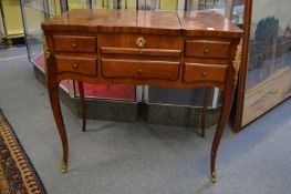 A French marquetry inlaid mahogany dressing table, the central section with rising mirror.