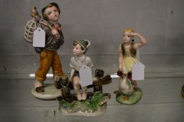 A group of three Austrian figures depicting children.