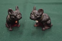 A pair of glass models of dogs.