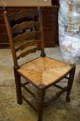 A set of four rush seated ladderback dining chairs and an occasional chair.
