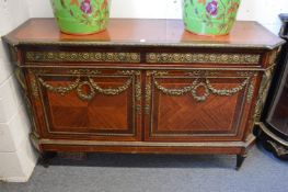 A French style ormolu mounted mahogany two drawer, two door commode.