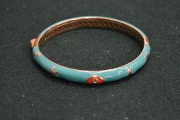 A turquoise enamel bangle.
