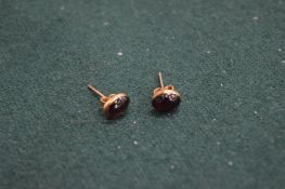 A pair of 9ct gold and amethyst ear studs.