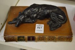 Paperweight modelled as a bronze greyhound on a leather book.