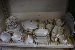 A quantity of Clarice Cliff dinnerware, grey ground with gilt borders.