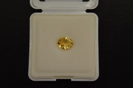 An oval cut citrine, boxed with certificate.