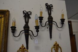 A set of four black Japanned twin branch wall lights.