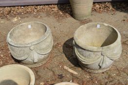 A pair of classical style reconstituted stone planters.
