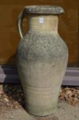 A large earthenware jug style planter or vase.