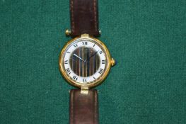 A ladies Must de Cartier quartz wristwatch with gilt metal case and leather strap, complete with