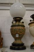 A Victorian green and brown glaze pottery oil lamp.