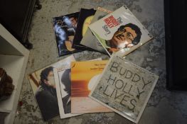 Buddy Holly and other LP records.