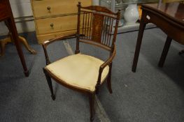 An Edwardian inlaid mahogany open armchair.