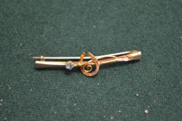 A 9ct gold and gem set hunting brooch.