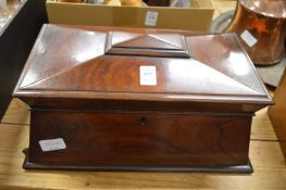 A Victorian rosewood sarcophagus shaped tea caddy or storage box.