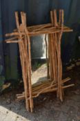 A rustic exterior wall mirror.