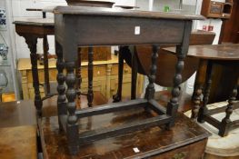 An oak occasional table on bobbin turned supports.