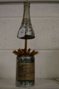 A stylish cigarette dispenser modelled as a White Star Moet and Chandon champagne bottle, the rising