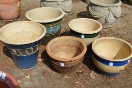 Five decorative glazed plant pots.