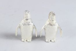 A SMALL PAIR OF SILVER PLATE PENGUIN SALT AND PEPPERS.