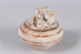 A GREEK POTTERY CIRCULAR VESSEL. 4ins diameter.