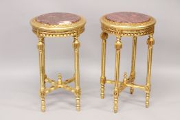 A PAIR OF CIRCULAR TOP TABLES. 2ft 3ins high x 1ft 4ins diameter.