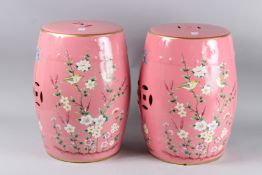 A PAIR OF PINK CHINESE DESIGN FLORAL BAR STOOLS. 18ins high.