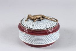 A SEVRES DESIGN CIRCULAR PORCELAIN BOX AND COVER with lizard handle. 5ins diameter.