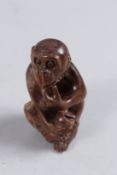 A JAPANESE CARVED WOODEN MONKEY.