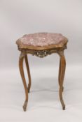 A MAHOGANY SHAPED MARBLE TOP TABLE on four curving legs. 2ft 4ins high x 1ft 10ins wide.