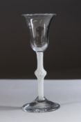 A GEORGIAN WINE GLASS with inverted bell bowl and cream air twist stem. 6ins high.