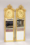 A PAIR OF LOUIS XVI STYLE LONG NARROW MIRRORS with oval gilt panels of ladies. 5ft 10ins high x
