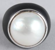 A LARGE 18CT GOLD PEARL RING with black shank.