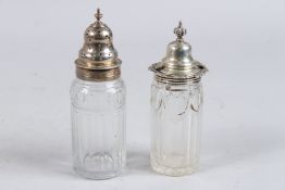 A PAIR OF SILVER TOP GLASS CRUETS.