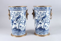 A GOOD PAIR OF BLUE AND WHITE PORCELAIN VASES decorated with parrots, with gilt metal handles and