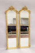 A PAIR OF LOUIS XVI STYLE GILTWOOD LONG MIRRORS. 5ft 9ins high x 1ft 6ins wide.