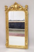 A GOOD LOUIS XVI STYLE GILTWOOD MIRROR with scrolls and cupids. 6ft high x 2ft 8ins wide.