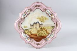A LARGE PINK GROUND SQUARE SEVRES DESIGN PLATE painted with a chateau. 18ins.