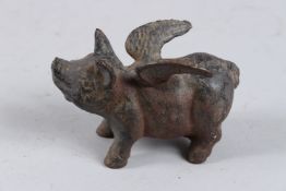 A CAST IRON FLYING PIG.